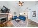 Bright and airy living room featuring a fireplace, vaulted ceilings, and seamless flow into the kitchen at 3831 Portland Trail Dr, Suwanee, GA 30024