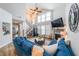 Bright living room showcasing high ceilings, staircase, and an inviting blue sectional sofa at 3831 Portland Trail Dr, Suwanee, GA 30024