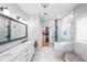 Beautiful main bathroom with tiled walk-in shower, dual sinks, and access to a spacious walk-in closet at 3831 Portland Trail Dr, Suwanee, GA 30024