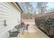 Enjoy outdoor living on this patio with a small table, chairs, and privacy landscaping at 3831 Portland Trail Dr, Suwanee, GA 30024