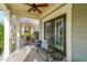 Inviting covered front porch features seating, an area rug, and double doors to the home's entrance at 3831 Portland Trail Dr, Suwanee, GA 30024