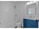 Bathroom with white tile surround and blue vanity at 473 Silverleaf Ln, Dallas, GA 30157