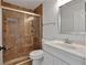 Bathroom featuring tiled shower with glass doors, white vanity and sink at 473 Silverleaf Ln, Dallas, GA 30157