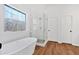 Primary bathroom features a modern soaking tub and a glass-enclosed shower at 473 Silverleaf Ln, Dallas, GA 30157