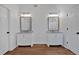 Bathroom includes double sinks, vanity mirrors, and white cabinets at 473 Silverleaf Ln, Dallas, GA 30157