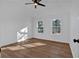 Bright bedroom featuring hardwood floors, ceiling fan, and natural light at 473 Silverleaf Ln, Dallas, GA 30157