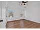 Bright bedroom with hardwood floors, two windows, and ceiling fan at 473 Silverleaf Ln, Dallas, GA 30157