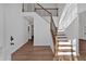 Bright foyer with wood floors, staircase, and freshly painted walls, creating a welcoming entrance at 473 Silverleaf Ln, Dallas, GA 30157