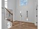 Bright foyer with wood floors, staircase, and freshly painted walls, creating a welcoming entrance at 473 Silverleaf Ln, Dallas, GA 30157