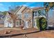Charming two-story home featuring a stone facade, attached garage, and well-maintained landscaping at 473 Silverleaf Ln, Dallas, GA 30157