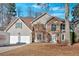 Charming two-story home featuring a stone facade, attached garage, and well-maintained landscaping at 473 Silverleaf Ln, Dallas, GA 30157