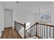 Hallway with hardwood floors and wrought iron railing overlooking main level at 473 Silverleaf Ln, Dallas, GA 30157