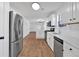 Modern kitchen with stainless steel appliances, white cabinetry, and a functional layout at 473 Silverleaf Ln, Dallas, GA 30157
