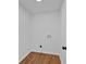 Small laundry room provides basic hookups and wood flooring at 473 Silverleaf Ln, Dallas, GA 30157