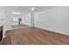 Open living room showing wood floors, and seamlessly flowing into the kitchen at 473 Silverleaf Ln, Dallas, GA 30157