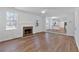 Bright living room featuring wood floors, a fireplace, and an open concept to the kitchen at 473 Silverleaf Ln, Dallas, GA 30157