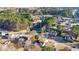 Aerial view of houses in a wooded neighborhood with a pond at 473 Silverleaf Ln, Dallas, GA 30157
