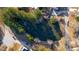 Aerial view of a pond surrounded by trees and houses in a neighborhood at 473 Silverleaf Ln, Dallas, GA 30157