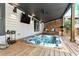 Outdoor hot tub on a wooden deck with a bench and a view of the backyard at 10195 Kinross Rd, Roswell, GA 30076