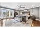 Spacious main bedroom with stylish furniture, hardwood floors, bay window and a calm color palette at 10195 Kinross Rd, Roswell, GA 30076