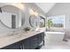 Elegant bathroom with double sinks, soaking tub, and large window at 1685 Bullard Rd, Powder Springs, GA 30127