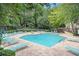 Large community pool surrounded by lounge chairs and lush greenery at 2501 Huntingdon Chase, Atlanta, GA 30350