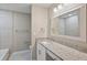 Bathroom featuring granite counters, a large mirror, and a tub at 25213 Plantation Ne Dr # 25213, Atlanta, GA 30324