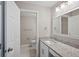 Modern bathroom featuring a granite counter top and tiled shower at 25213 Plantation Ne Dr # 25213, Atlanta, GA 30324