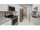 Modern kitchen boasts stainless steel appliances, granite counters, and white cabinetry at 25213 Plantation Ne Dr # 25213, Atlanta, GA 30324