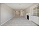 Open-concept living room with a fireplace, built-ins, and dining area at 25213 Plantation Ne Dr # 25213, Atlanta, GA 30324