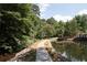 A charming view of a pond and a wooded trail on a sunny day at 25213 Plantation Ne Dr # 25213, Atlanta, GA 30324