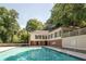 Community pool with trees and lounge chairs at 25213 Plantation Ne Dr # 25213, Atlanta, GA 30324