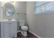 Bathroom featuring vanity, toilet, mirror and window at 1137 2Nd Nw St, Atlanta, GA 30318