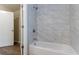 A bathroom featuring tiled walls, and a soaking tub with shower at 1137 2Nd Nw St, Atlanta, GA 30318