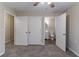 Bedroom featuring three doors leading to a bathroom and closets, with carpeted floors at 1137 2Nd Nw St, Atlanta, GA 30318