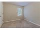 This bedroom features neutral walls, carpeted floors, and a window for natural light at 1137 2Nd Nw St, Atlanta, GA 30318
