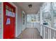 Cozy front porch featuring wood decking and white railings leading to a red front door at 1137 2Nd Nw St, Atlanta, GA 30318