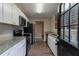 Modern kitchen featuring stainless steel appliances, granite countertops, and white cabinets at 1137 2Nd Nw St, Atlanta, GA 30318