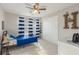 Colorful bedroom with sporty decor, a cozy bed, and ample storage at 244 Hiawassee Dr, Woodstock, GA 30188