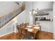 Dining area with hardwood floors connecting to the kitchen and a staircase at 244 Hiawassee Dr, Woodstock, GA 30188