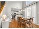 Elegant dining area with hardwood floors and modern lighting adjacent to the kitchen at 244 Hiawassee Dr, Woodstock, GA 30188