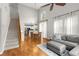 Bright living room with hardwood floors leading to the dining area and modern kitchen at 244 Hiawassee Dr, Woodstock, GA 30188