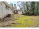 View of the backyard with a mossy lawn and stepping stones leading to the back of the house at 2096 Snow Sw Rd, Atlanta, GA 30311