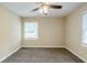 Bedroom with ceiling fan, plush carpeting, neutral paint, and bright window at 2096 Snow Sw Rd, Atlanta, GA 30311