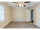 Bedroom with ceiling fan, plush carpeting, neutral paint, and doorway to other rooms at 2096 Snow Sw Rd, Atlanta, GA 30311
