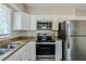 Kitchen with stainless steel appliances, granite countertops, and laminate floors at 2096 Snow Sw Rd, Atlanta, GA 30311