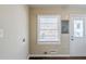 This laundry room features a window, a door to the outside, and electrical panel at 2096 Snow Sw Rd, Atlanta, GA 30311