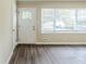 The home's living room area has new laminate floors and a large window at 2096 Snow Sw Rd, Atlanta, GA 30311