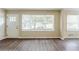 The home's living room area has new laminate floors and large windows at 2096 Snow Sw Rd, Atlanta, GA 30311