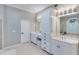 Well-lit bathroom featuring double sinks, a tiled shower, and ample storage at 2475 Gants Hill Pl, Cumming, GA 30041